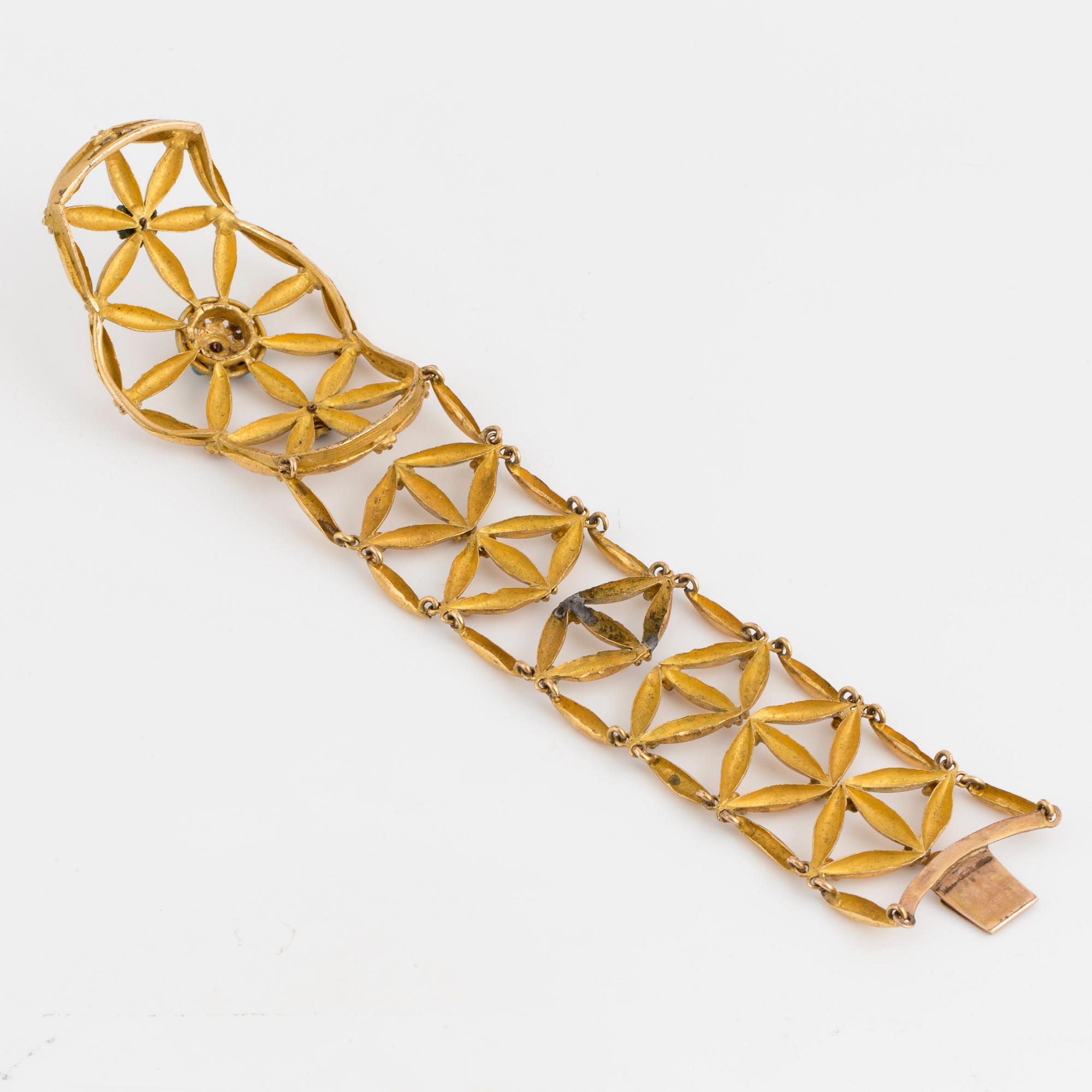 A 14K and low fineness gold bracelet set with blue stones.