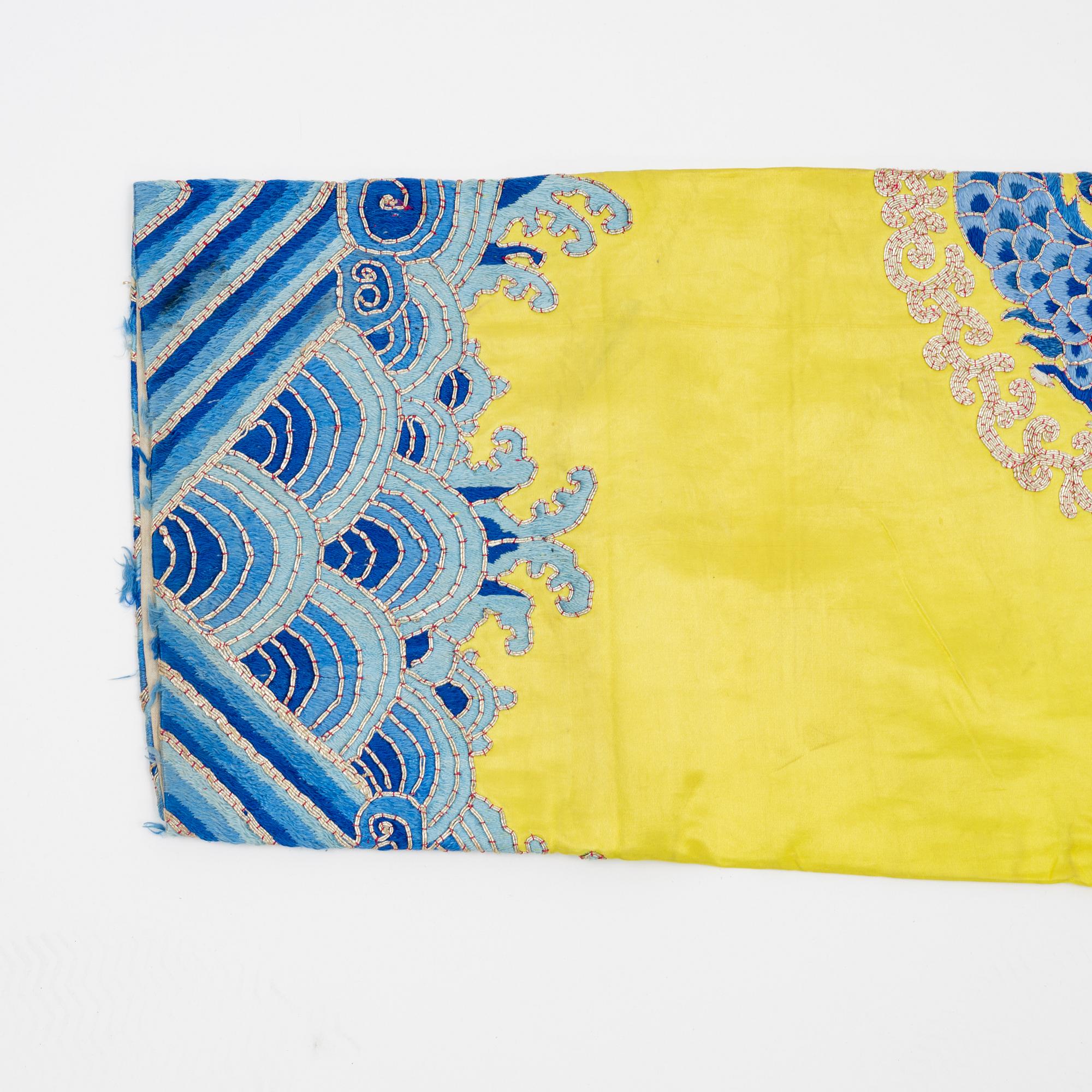 A yellow-ground embroidered silk robe, 20th century.