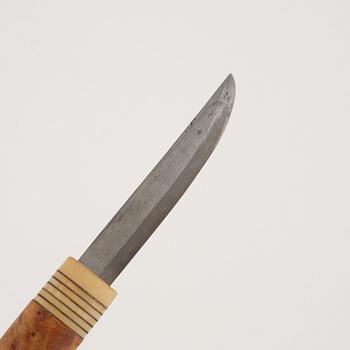 A reindeer horn knife, signed.