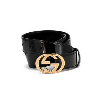 GUCCI, a black patent leather belt.