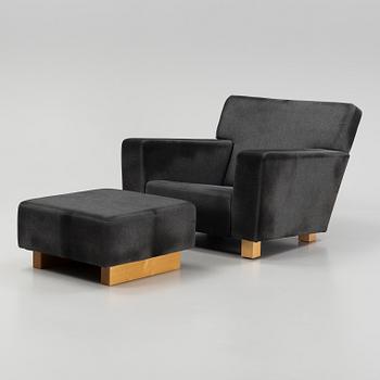 A model 3665 lounge chair with stool by Björn Trägårdh for Firma Svenskt Tenn.