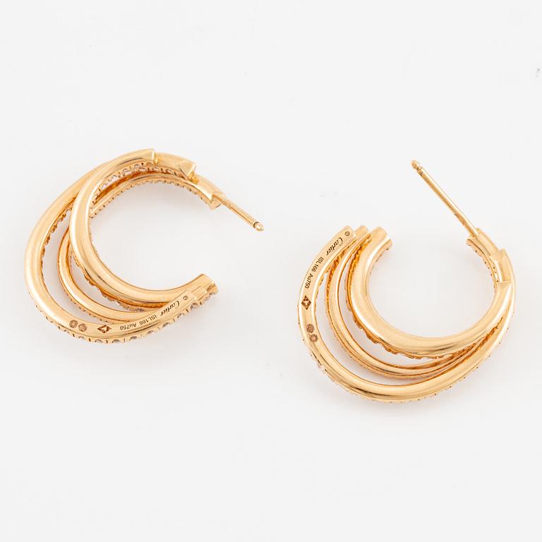 A pair of Cartier earrings in 18K gold set with round brilliant-cut diamonds.