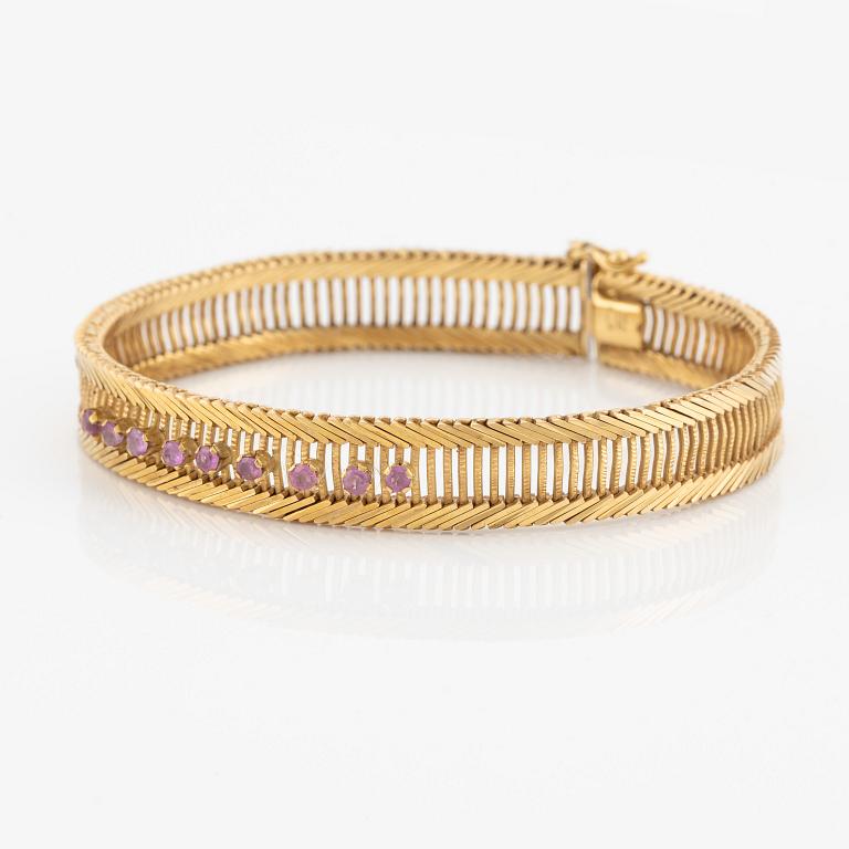 Bracelet 18K gold with pink stones.