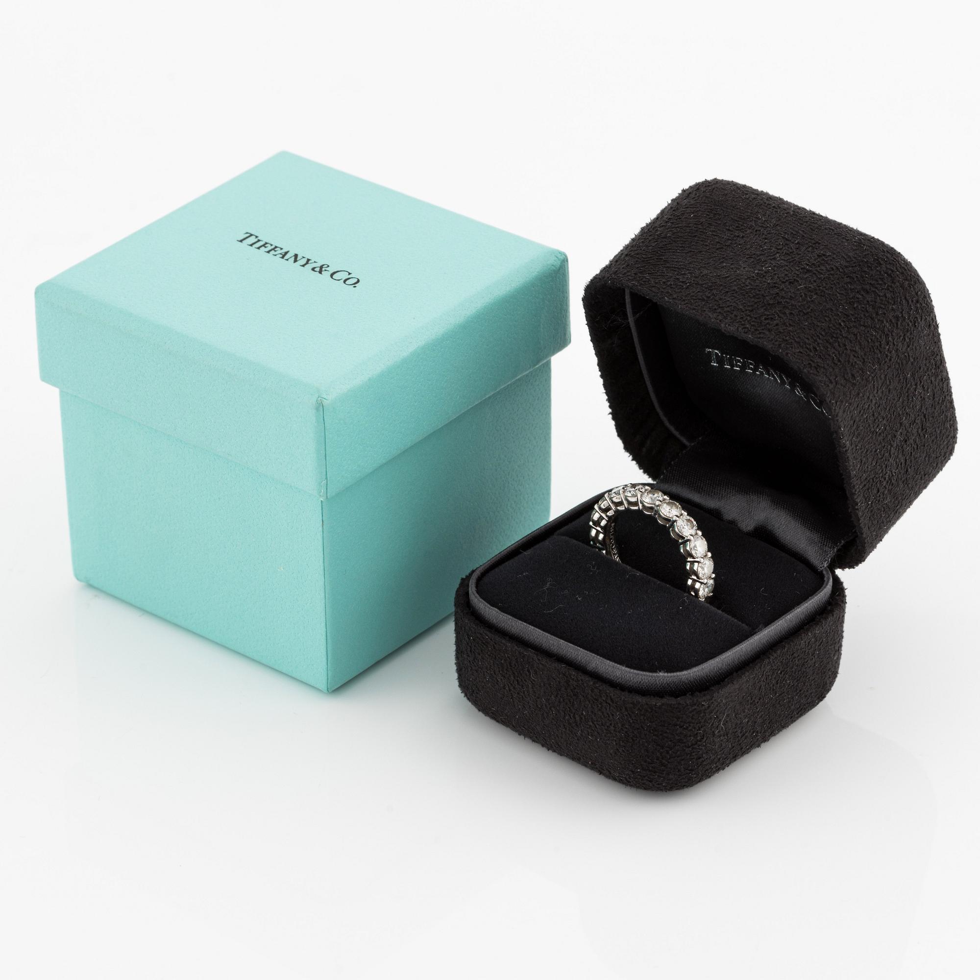 A platinum Tiffany & Co eternity ring set with round brilliant-cut diamonds.