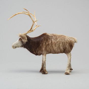 A Sami reindeer fur figure of a reindeer.