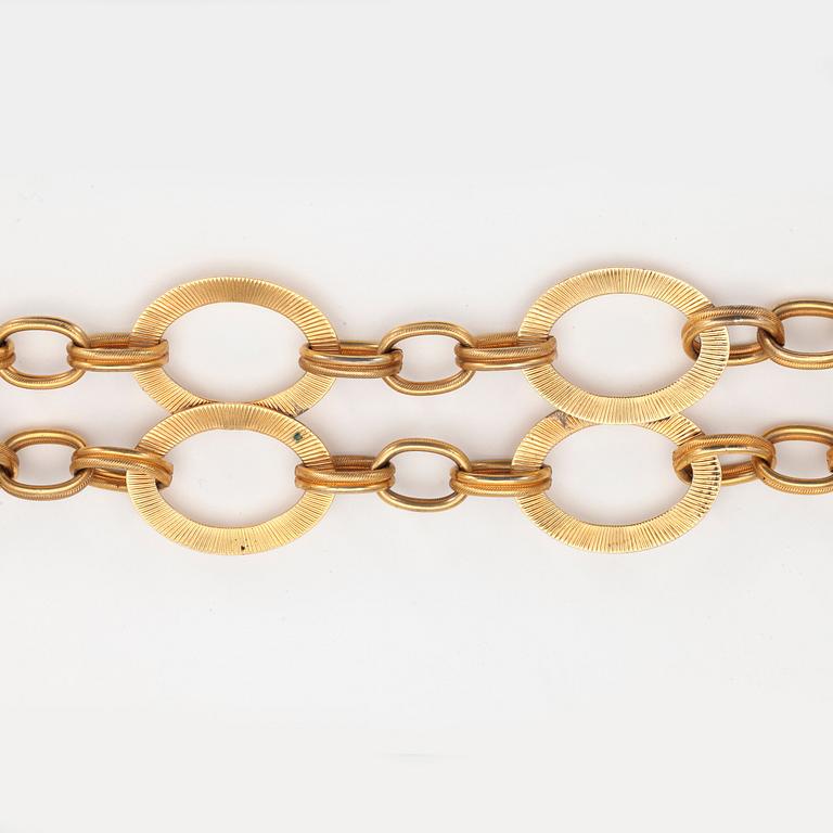 YVES SAINT LAURENT, a gold colored metal chain.