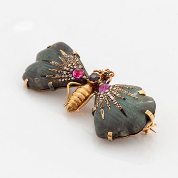 A butterfly brooch in 14K gold set with labradorite, rubies, rose-cut diamonds and garnets.