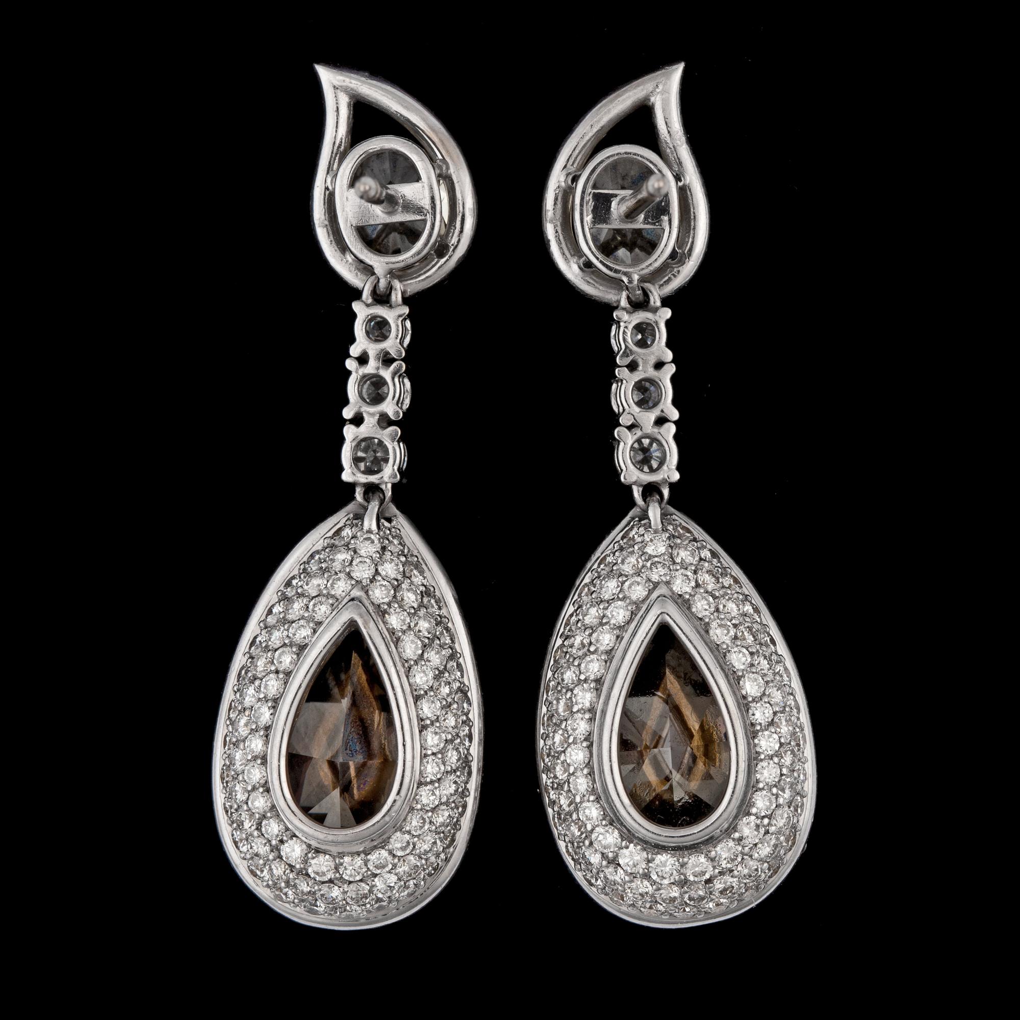 A pair of fancy yellow diamond earrings, 8.88 cts, resp. 8.88 cts each, and smaller white brilliant cut diamonds.