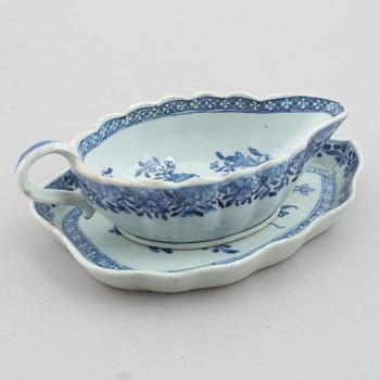 A blue and white vegetable tureen with cover and a sauce boat with a dish, Qing dynasty, 18th Century.