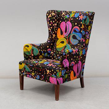 A 1960's/70's wing-chair with rosewwod legs.