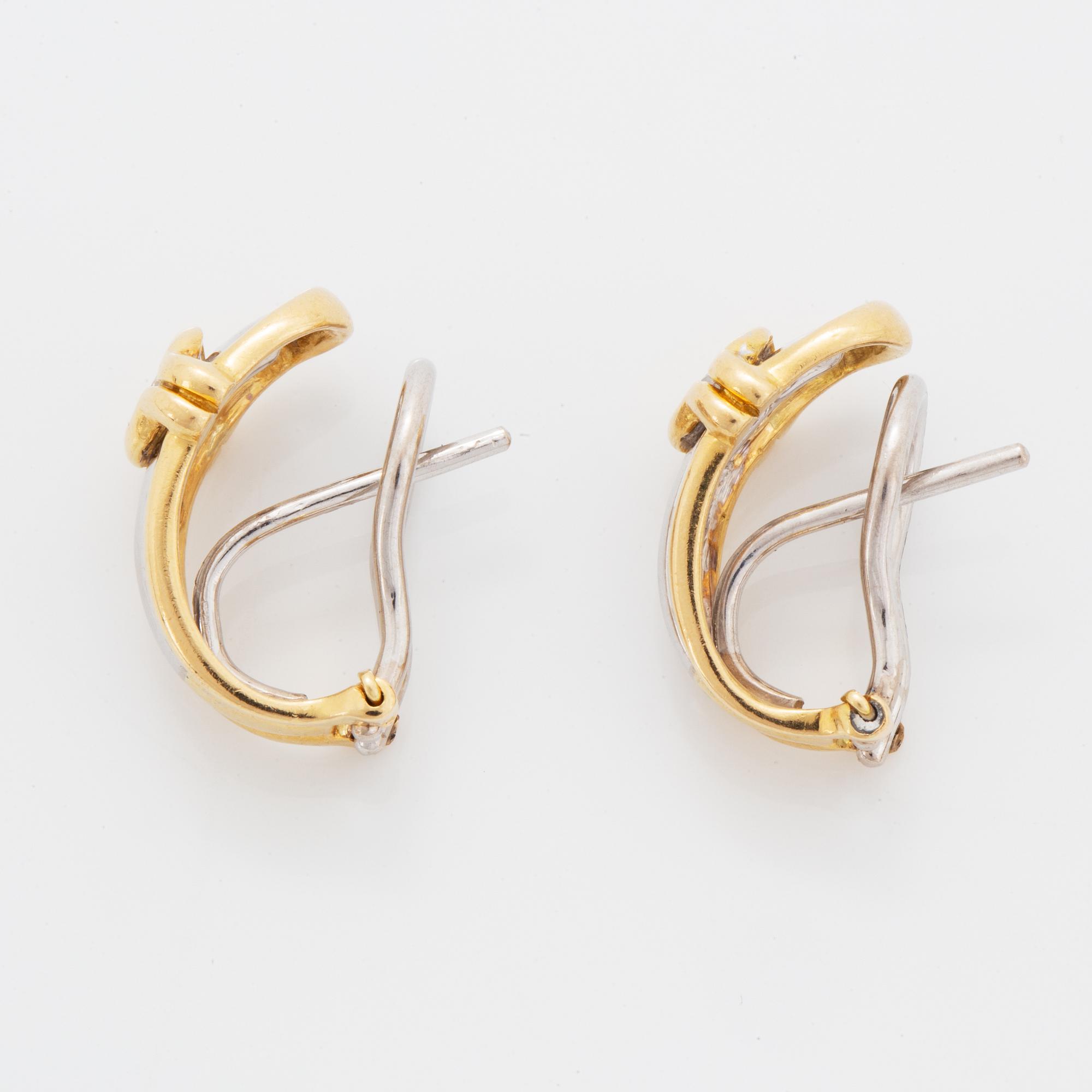 A pair of 18K gold earrings.
