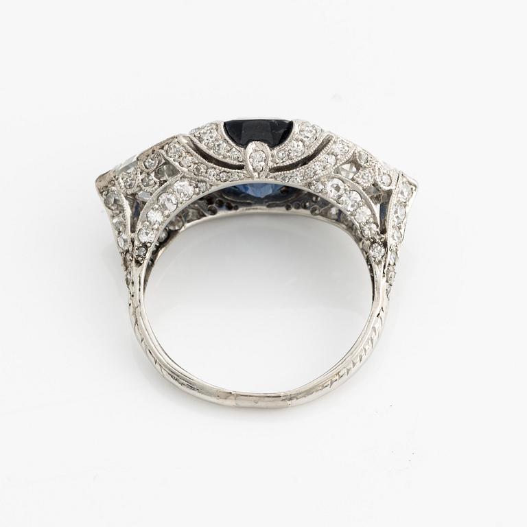 A platinum ring set with a faceted sapphire.