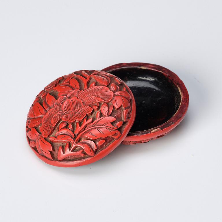 A Chinese red lacquer box with cover and a sculptured nephrite plaque, 20th Century.