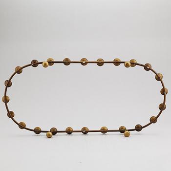 A mid 20th Century brass candle ring.