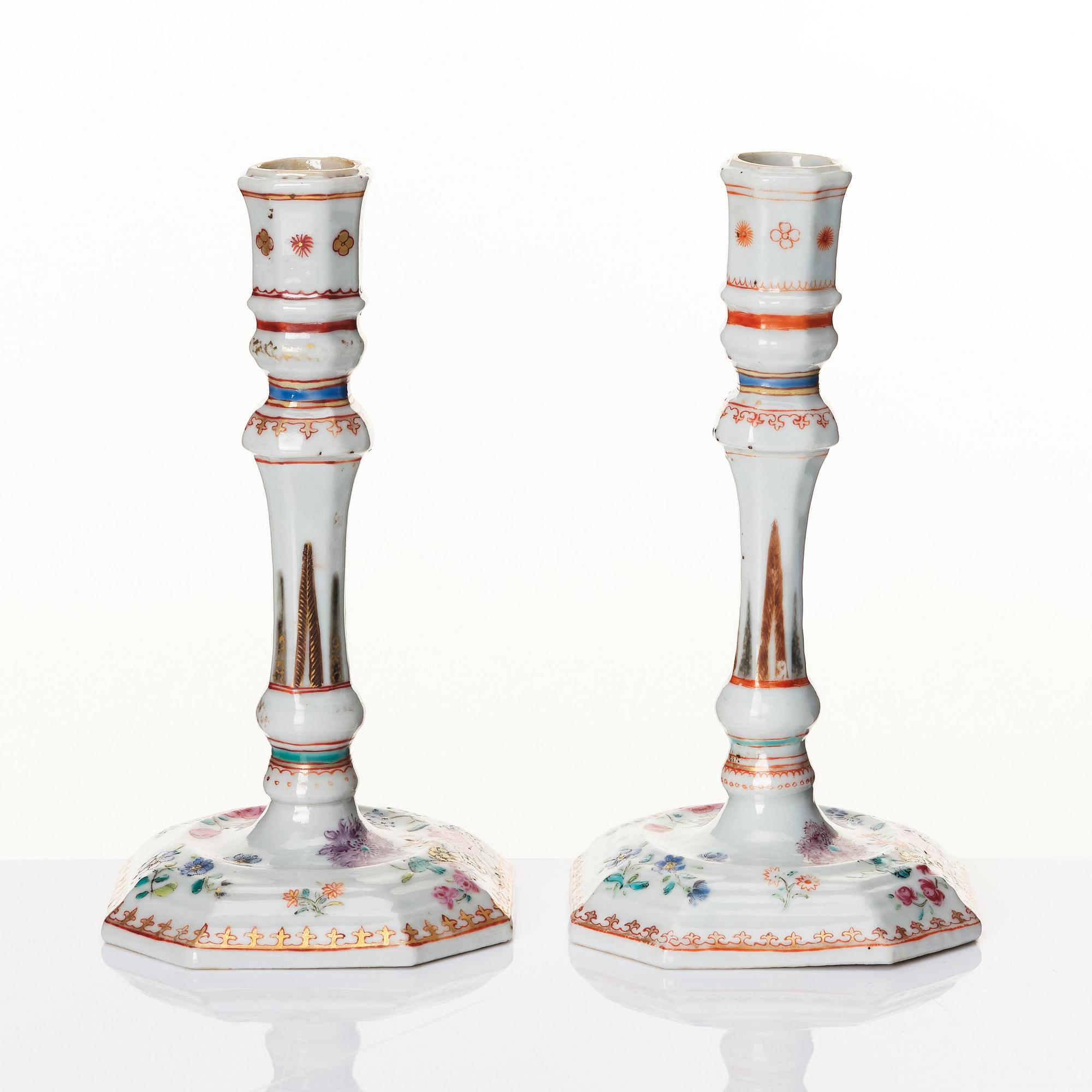 A pair of famille rose candles sticks, Qing dynasty, Qianlong (1736-95).