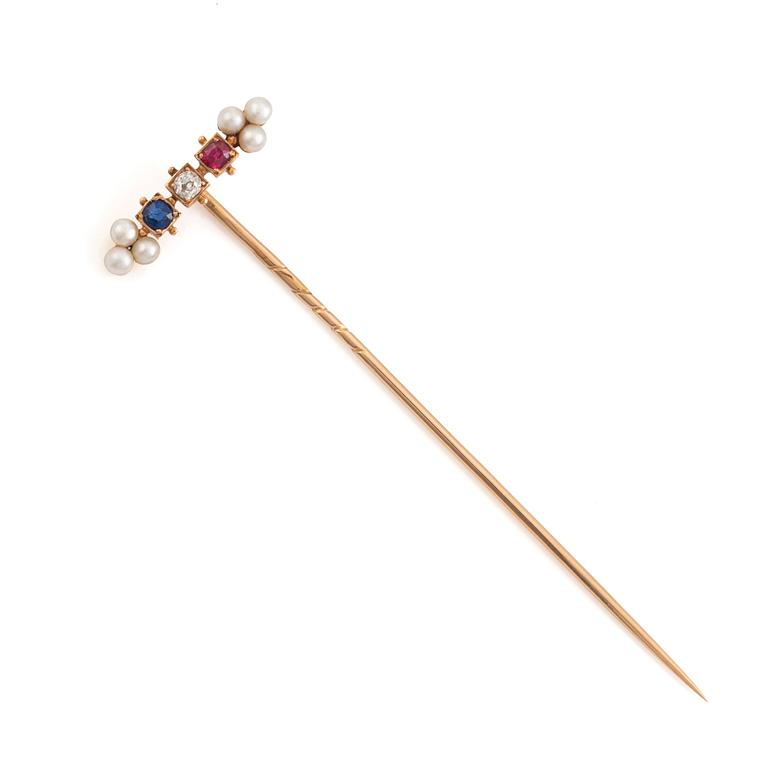 A 14K gold pin brooch with an old-cut diamond, pearls, and colored stones.