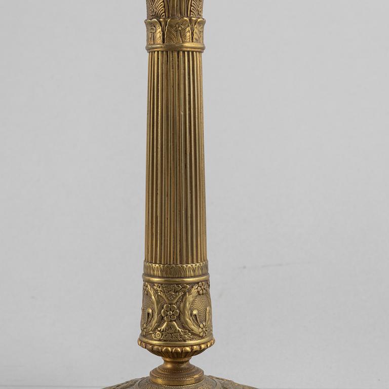 A pair of Empire gilt brass candle sticks, first half of the 20th century.