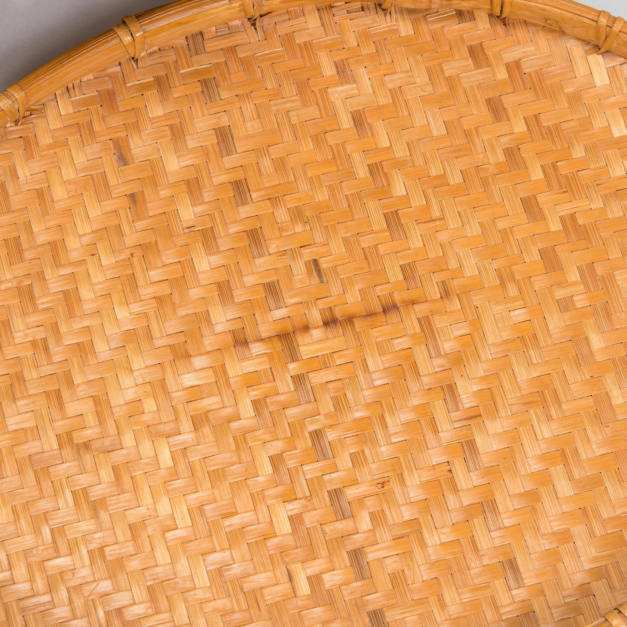 A mid-20th century rattan basket and two rattan trays. Retailer Artek Finland.