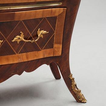A Swedish rosewood-veneered Rococo chest of drawers, later part of the 18th century.