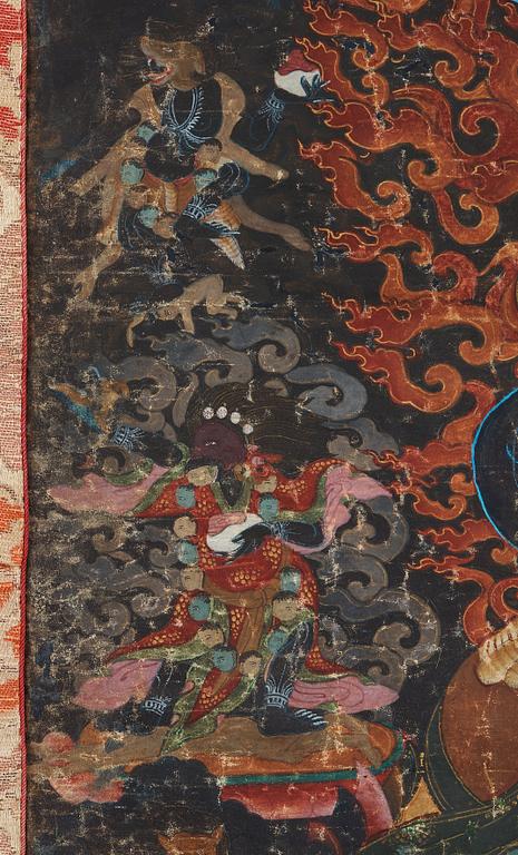 A Tibetan Thangka of Mahakala surrounded by fierce Dharma protectors, 19th century.