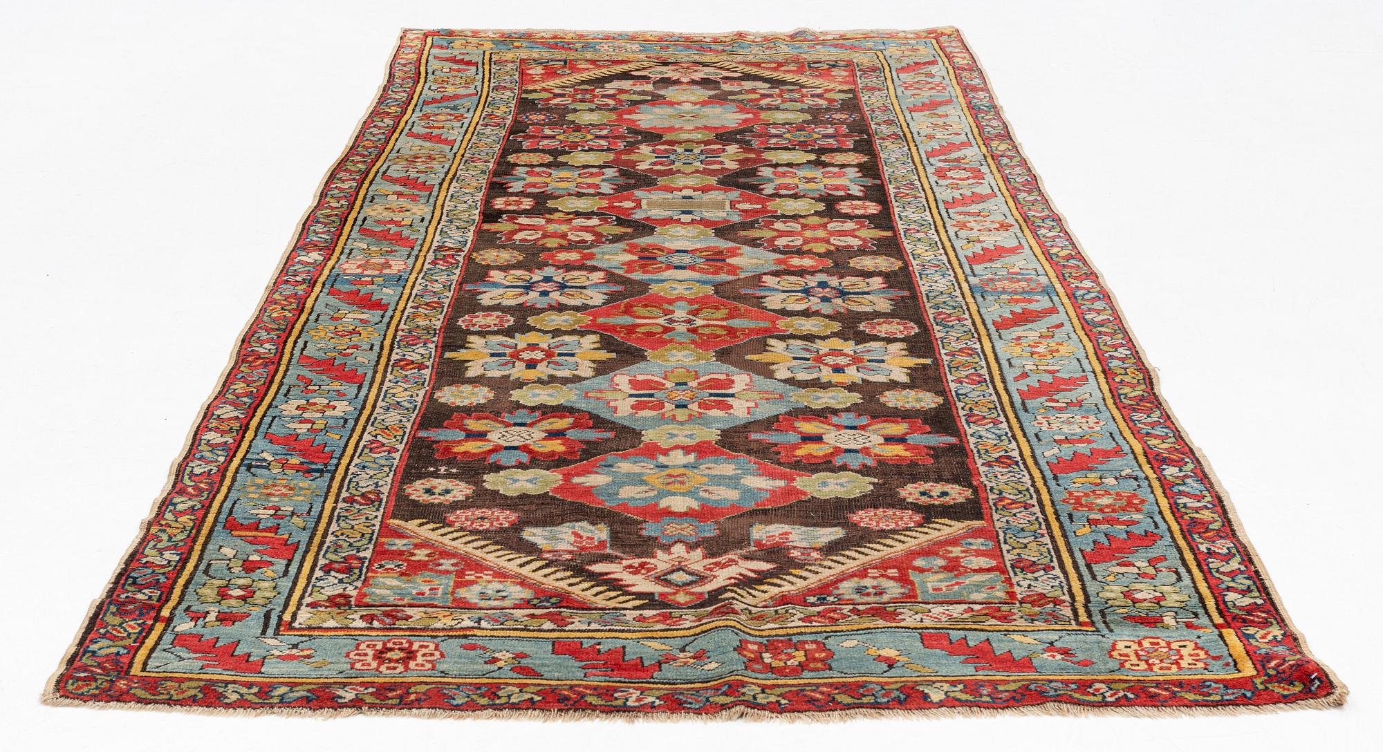 An antique Karabagh carpet,  ca 330 x 157 cm (one end with 1-3 cm flat weave).