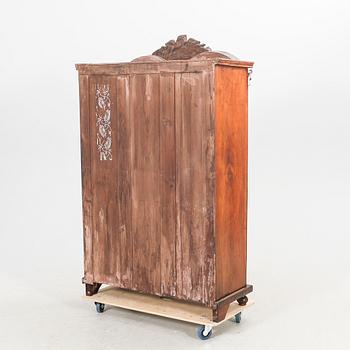 A walnut display cabinet around 1900.