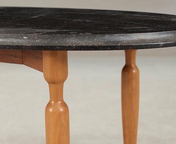 A Josef Frank black marble top table on a mahogany and walnut base, Svenskt Tenn, Sweden.