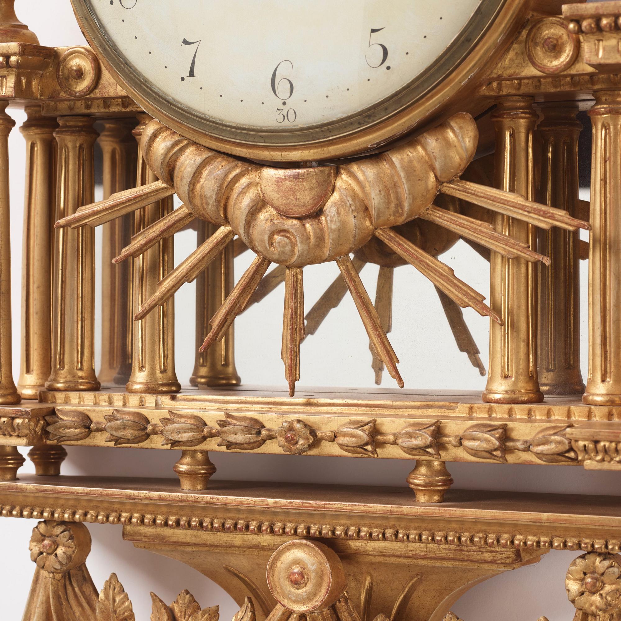 A Gustavian giltwood cartel clock by H. Wessman (watchmaker in Stockholm 1787-1805).