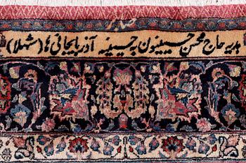 An antique Mashad carpet, signed Saber, c. 405 x 295 cm.
