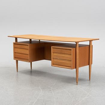 A teak veneered writing desk, 1950's/60's.