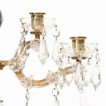 A pair of brass and glass canelabras, first half of the 20th century.