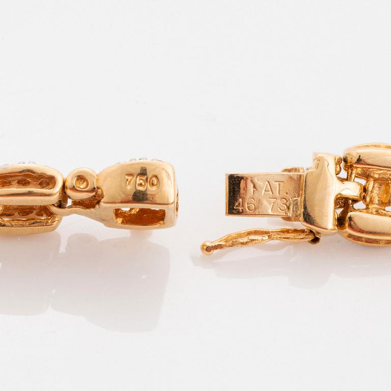 An 18K gold and white gold bracelet set with round brilliant-cut diamonds.