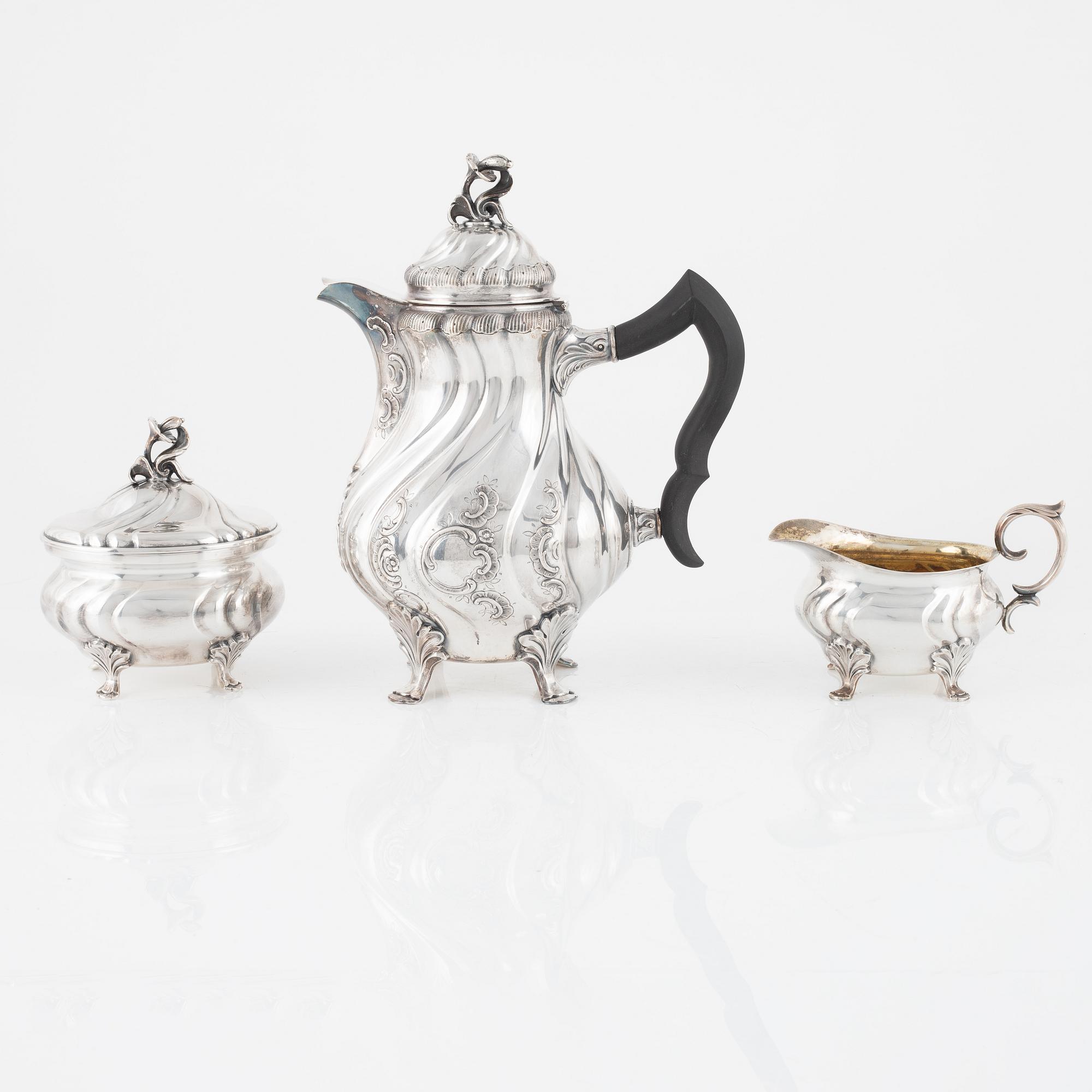 A silver coffee pot with creamer and sugarbox. CG Hallberg, Stockholm 1946.