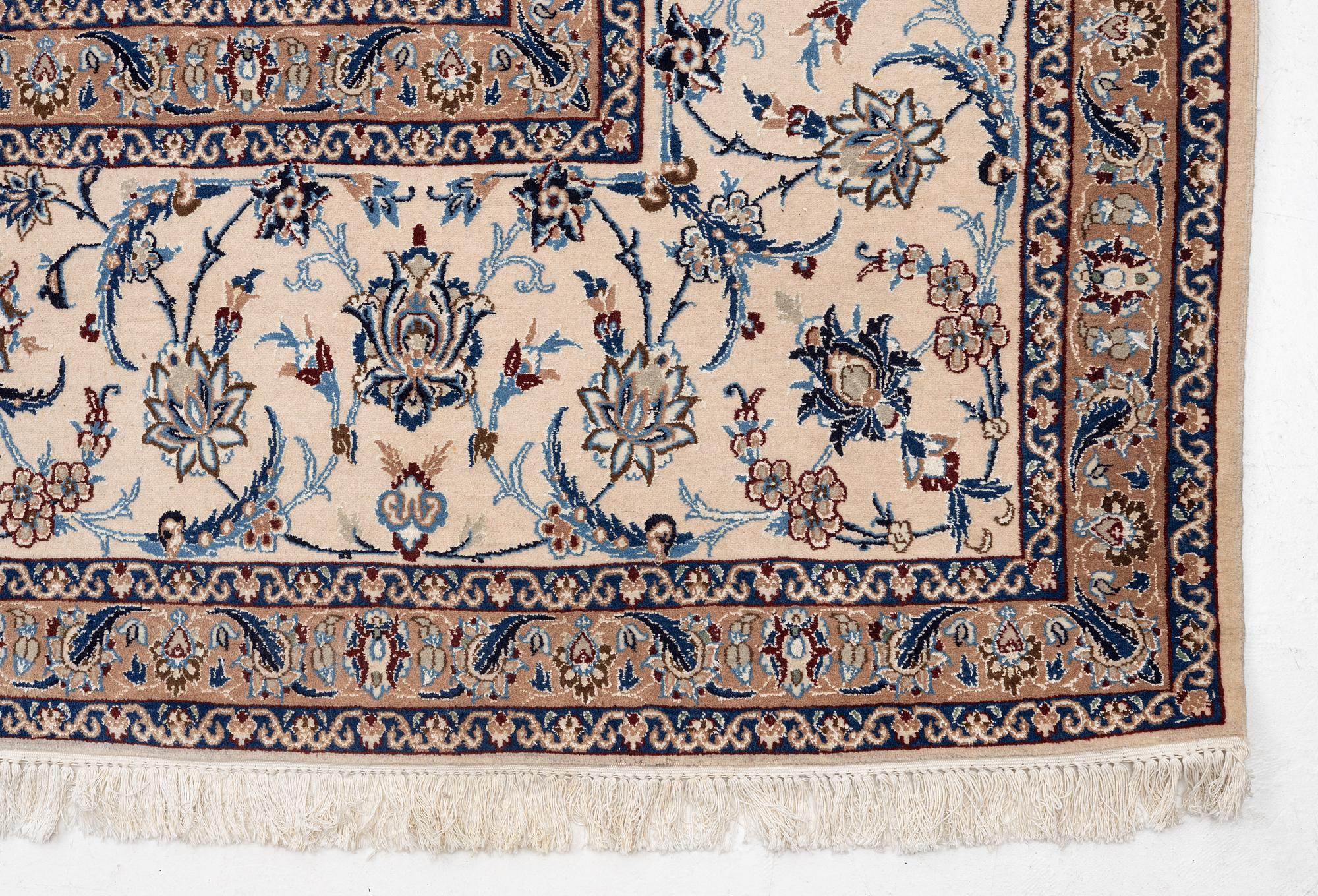 A Nain part silk carpet, c. 535 x 340 cm.