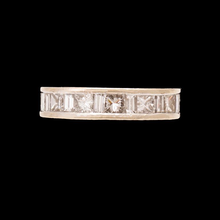 An 18K white gold eternity ring set with baguette and princess cut diamonds by Hartmann's Denmark.
