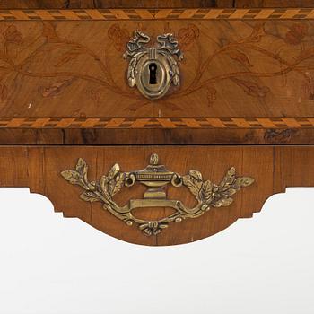 A Louis XVI-style marquetry and marble commode, later part of the 19th century.