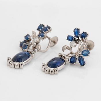 A pair of CF Carlman platinum earrings set with cabochon-cut and faceted sapphires.