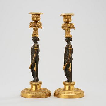 A pair of Empire early 19th century candlesticks.