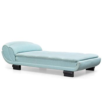 ART DÉCO, an upholstered daybed on shaped black lacquered wooden legs, 1920's-30's.