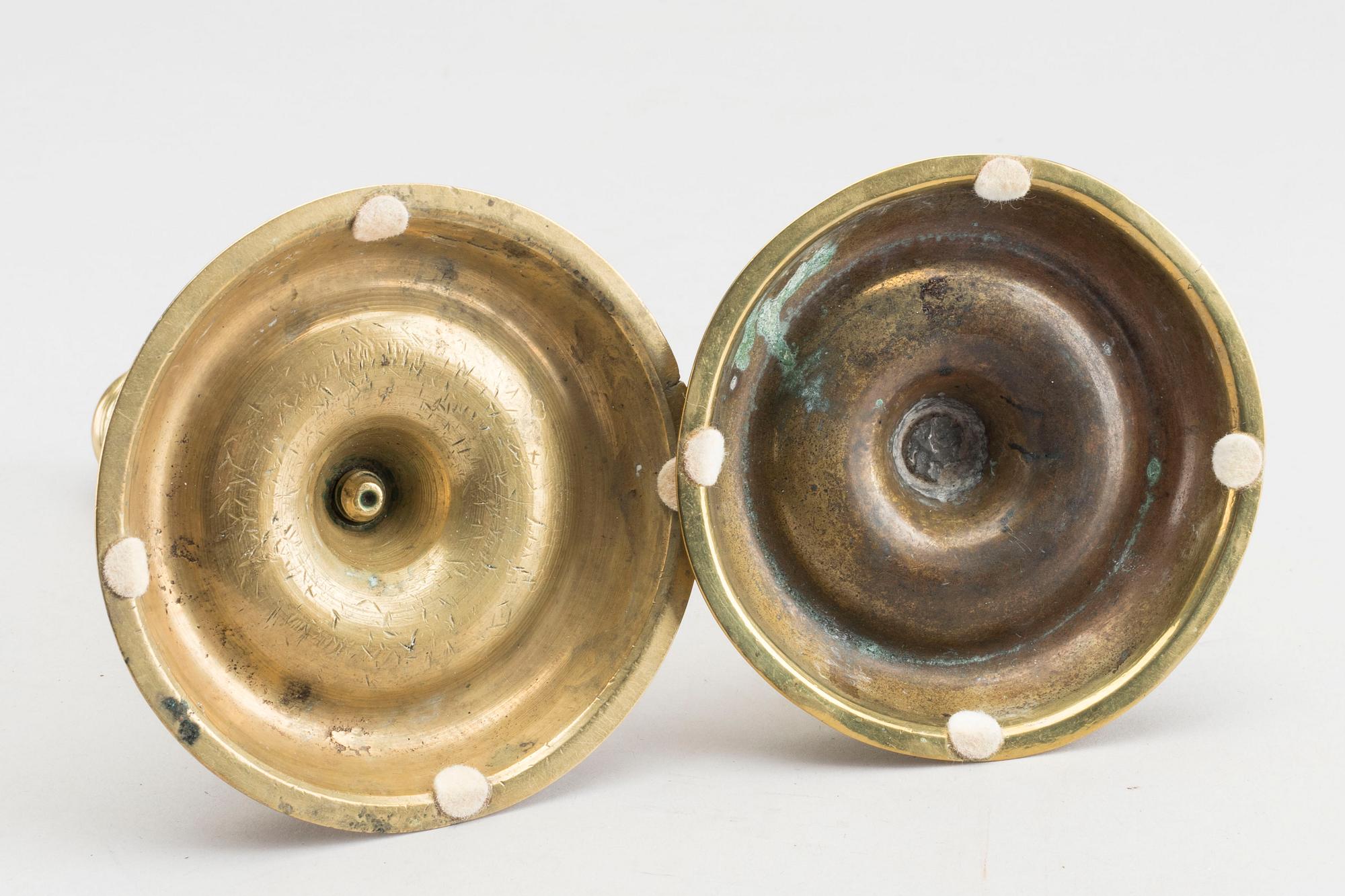 A set of two of brass candle sticks mid 18th century.