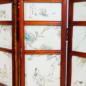 A Chinese folding screen with 48 porcelain tiles, late Qing dynasty, signed Ren Huanzhang, and dated 1881.