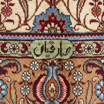 A signed Tabriz carpet, c 309 x 205 cm.