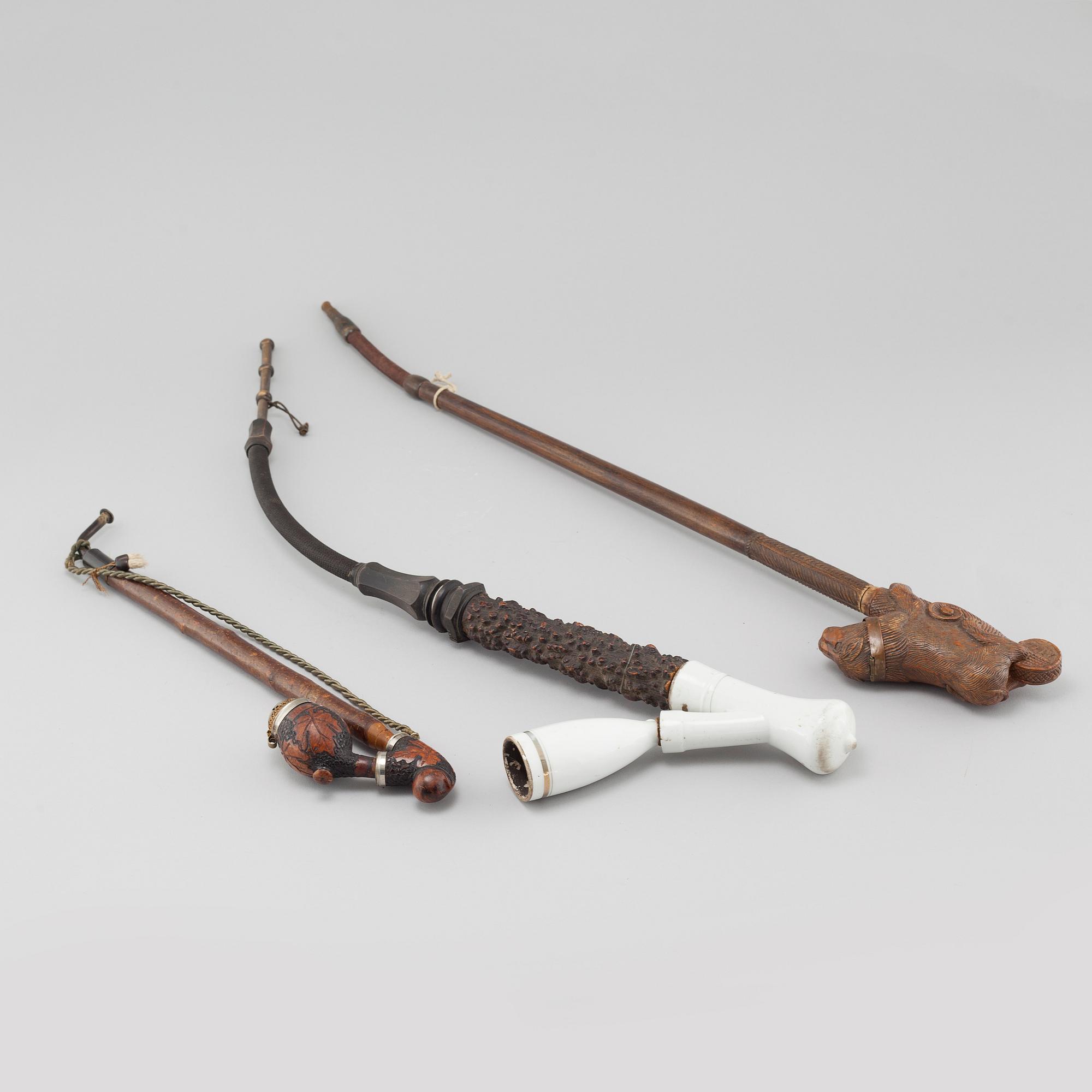Three mainly 19th century pipes, one dated 1711.