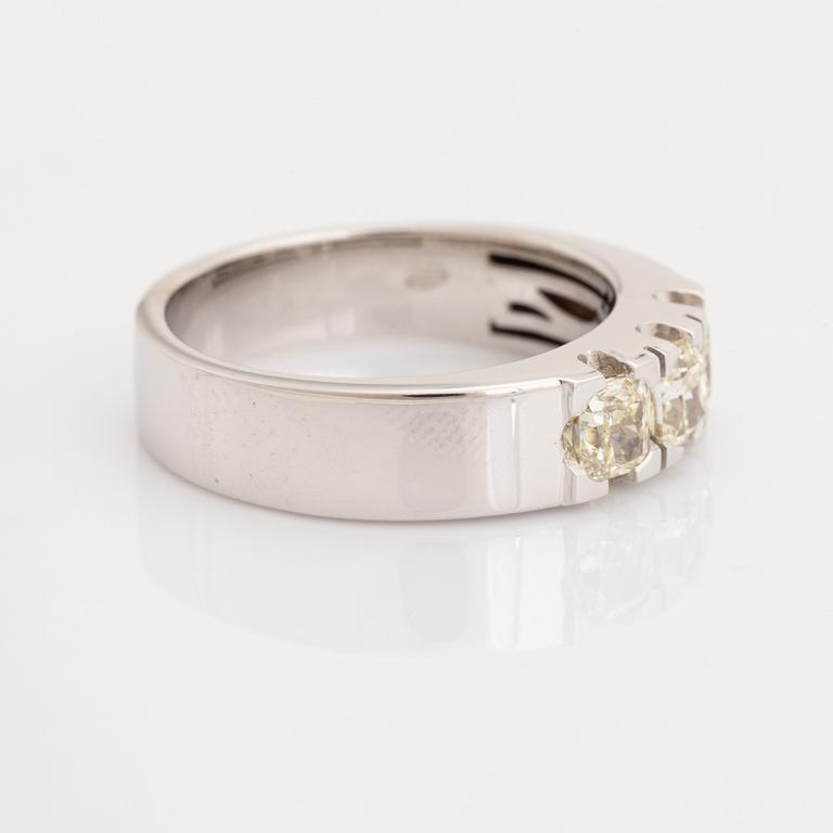 Cushion-cut diamond three stone ring.