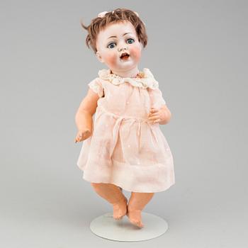 a porcelain doll from the early 20th century.