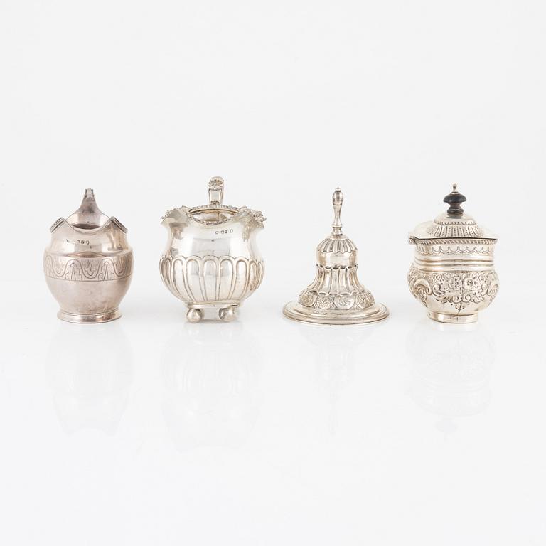 A silver bell, sugar box, and two creamers, including London 1811.