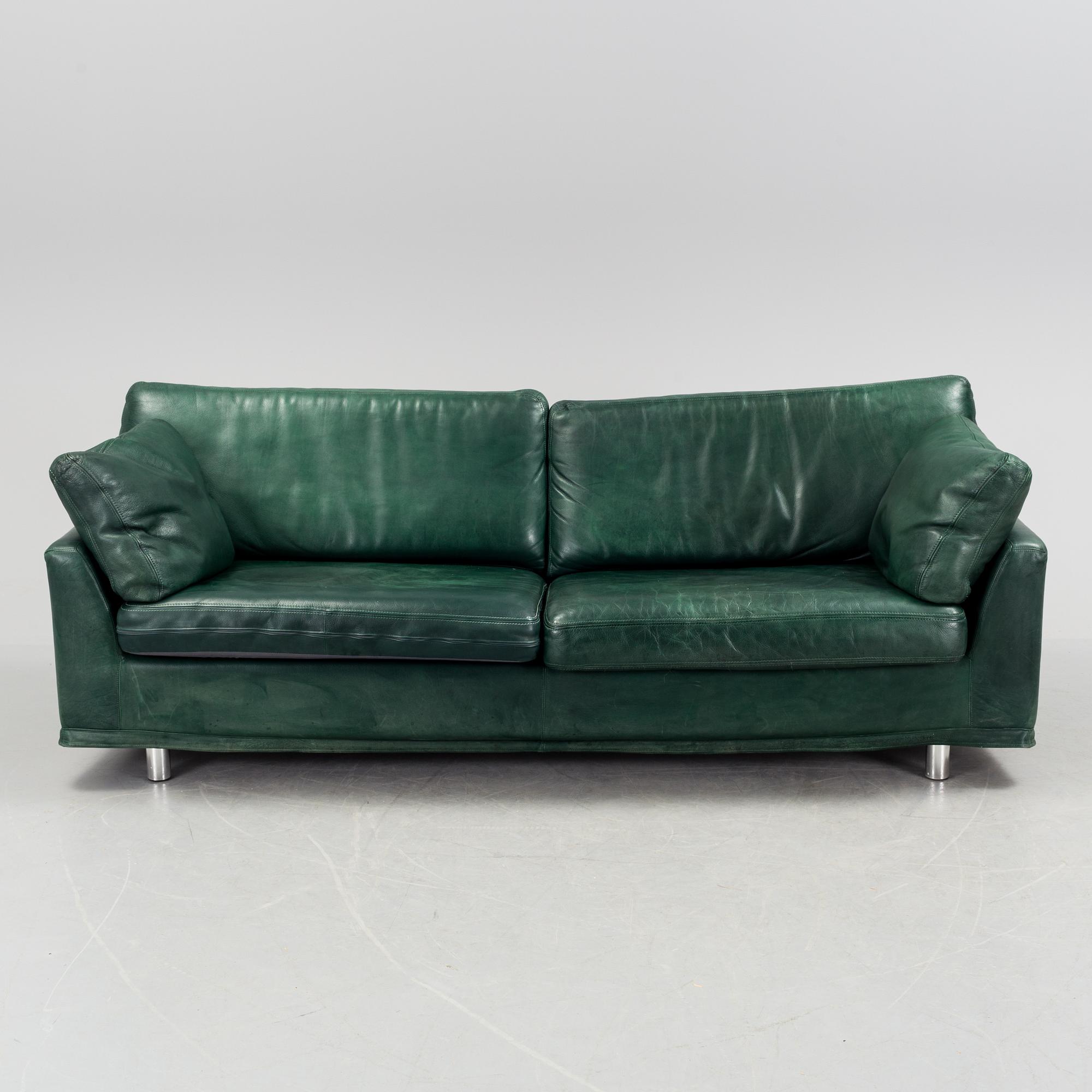 A "Fredrik" green leather sofa by Dux.