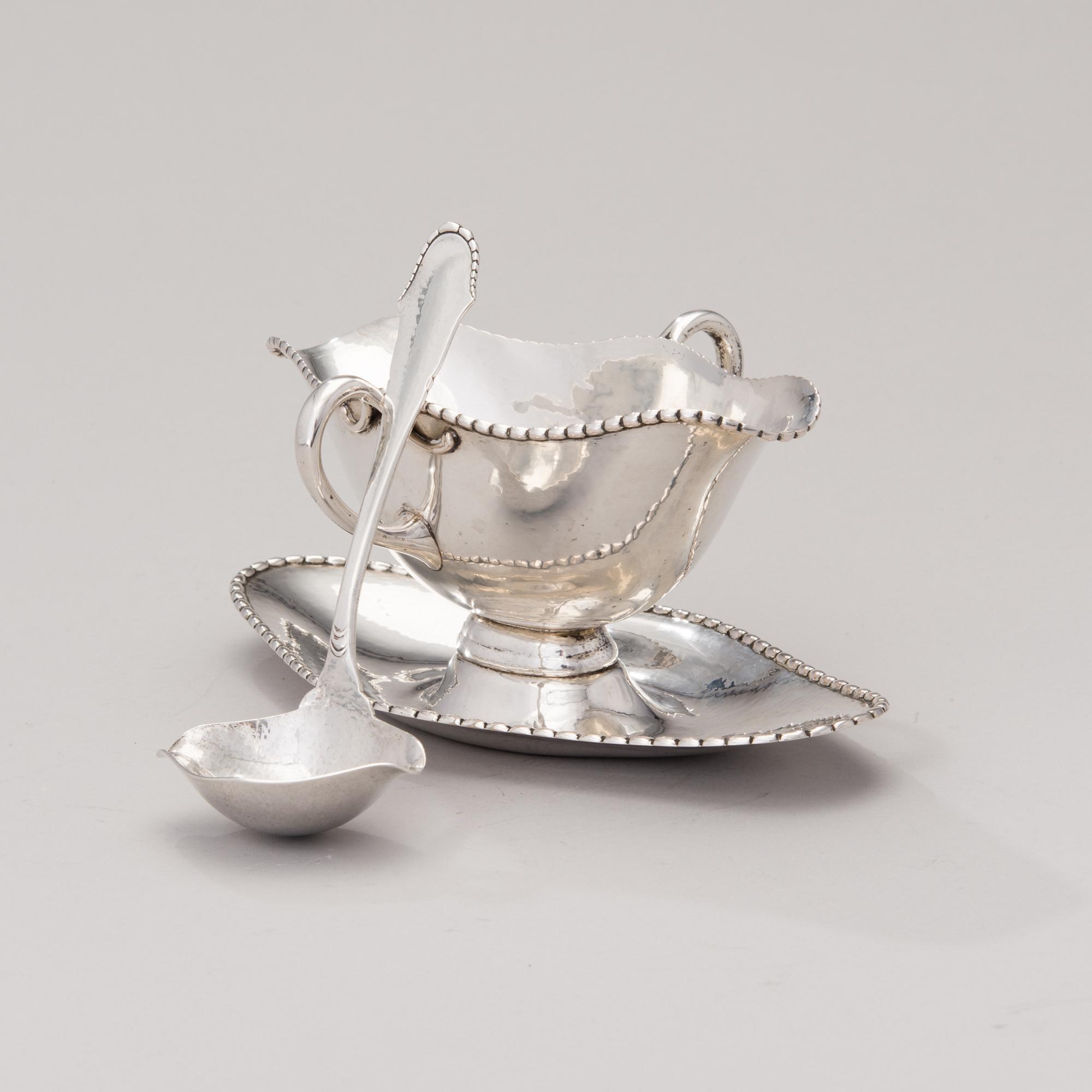 A sauce boat with a sauce ladle in silver, mark of Paul Bang, Copenhagen, Denmark 1929 and 1930s.