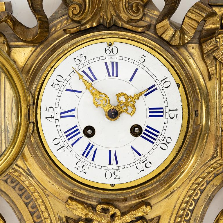 A bronze wall clock, Louis XVI style, France, circa 1900.