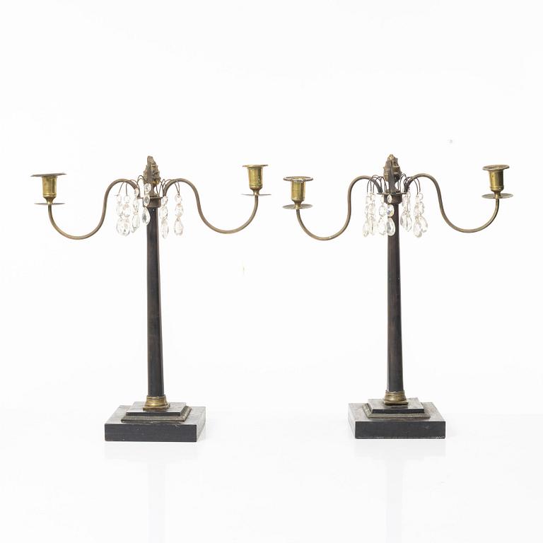 A pair of wooden candelabras, around 1900.